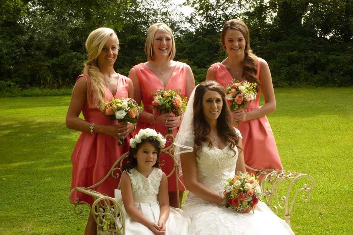 Bride and bridesmaids with flower bouquets