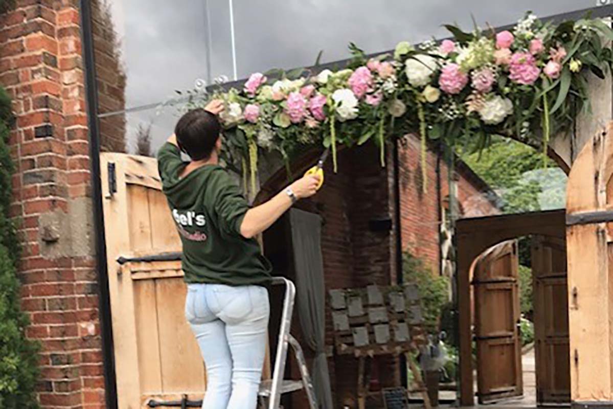 Florist in coventry setting up decorations for a wedding