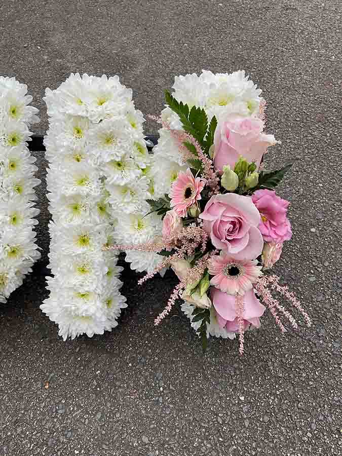 Pink flowers on an arrangement of roses and posies